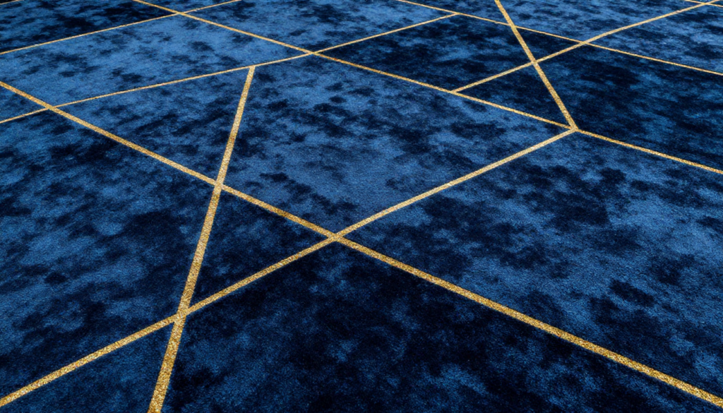 Blue geometric carpet tiles with gold intersecting lines design